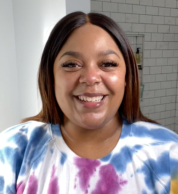 The reviewer's face glowing with radiance after applying the moisturizer