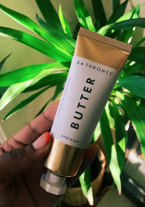 Amanda holding the tube of body butter