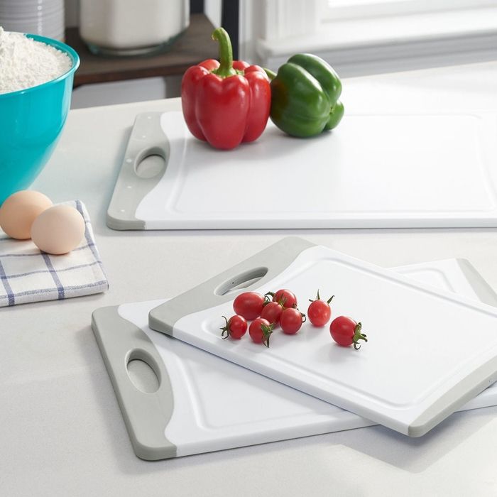 Three cutting boards featuring tomatoes and peppers, placed beside a blue bowl of rice and two eggs. This image is part of a Shopping article.
