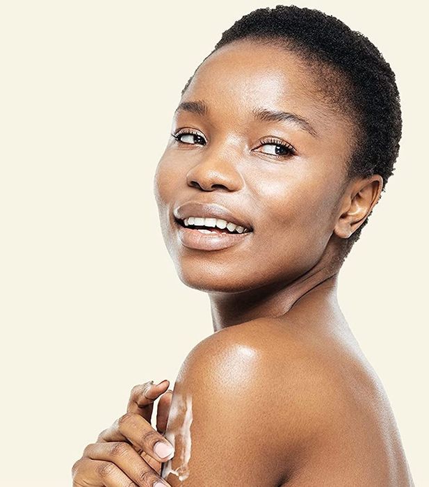 Model applying the lotion to their arm
