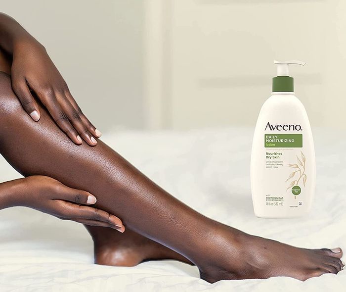 Model's legs placed next to the bottle of lotion