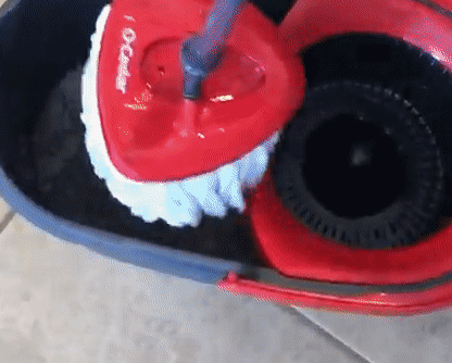 A reviewer demonstrating in a GIF how easily the mop is wrung out
