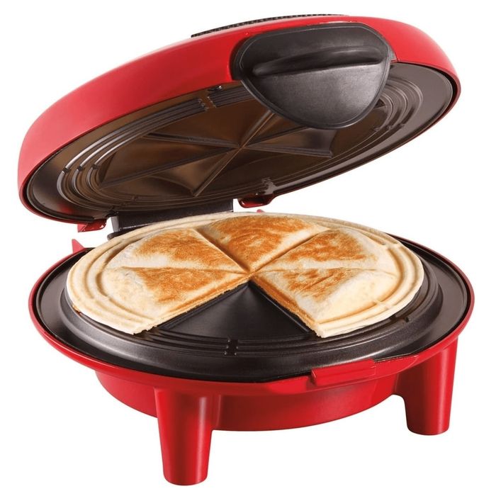 A red quesadilla maker with its lid open, displaying a cooked quesadilla sliced into four pieces, designed for effortless home cooking and slicing.
