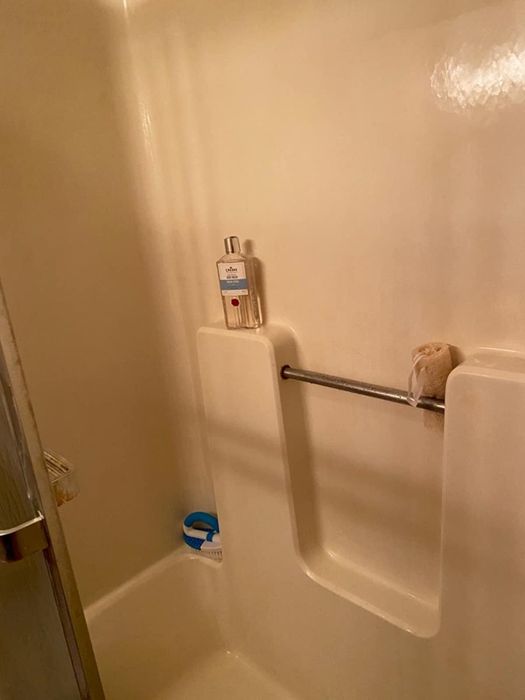 The same shower, now sparkling clean after using the hard-water stain remover