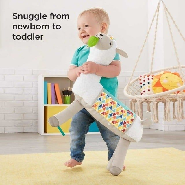 A toddler cuddling a soft, patterned sheep toy in a cozy playroom, promoting a comforting transitional snuggle companion for little ones.