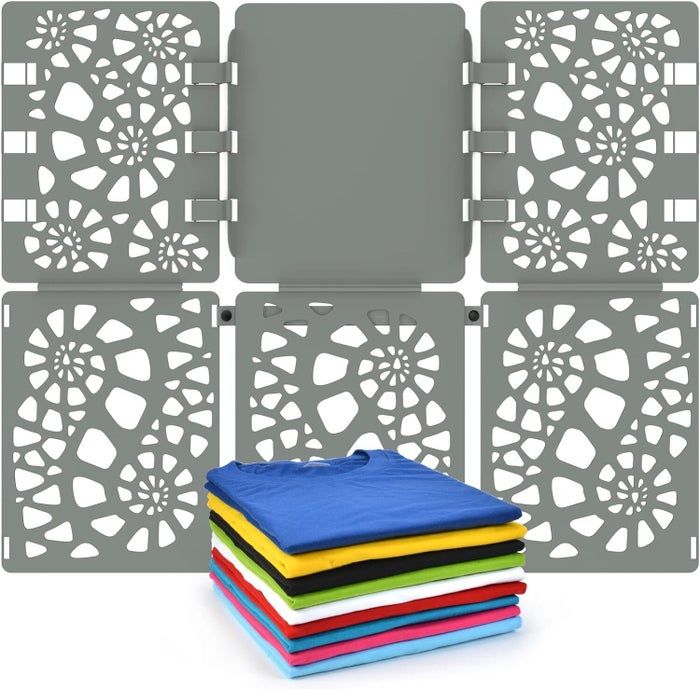A foldable plastic laundry folder adorned with a floral design, accompanied by a stack of neatly folded t-shirts in an assortment of vibrant colors