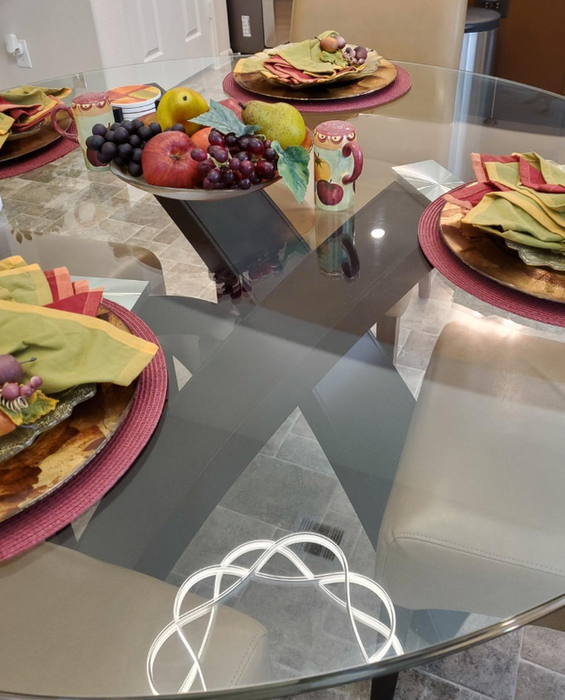 A tastefully arranged dining table adorned with a fruit centerpiece and coordinated placemats
