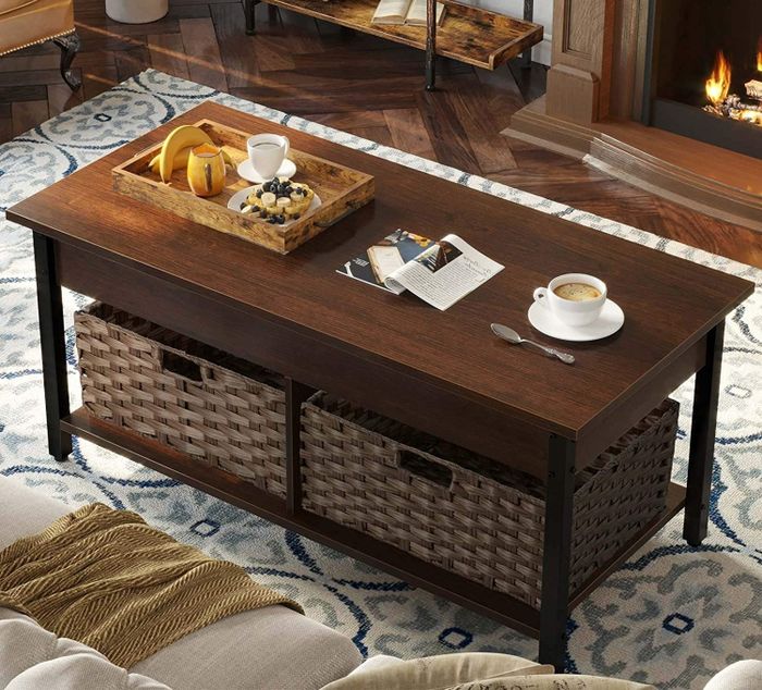 A brown coffee table with sleek black legs, featuring two woven baskets tucked away in the storage area underneath.