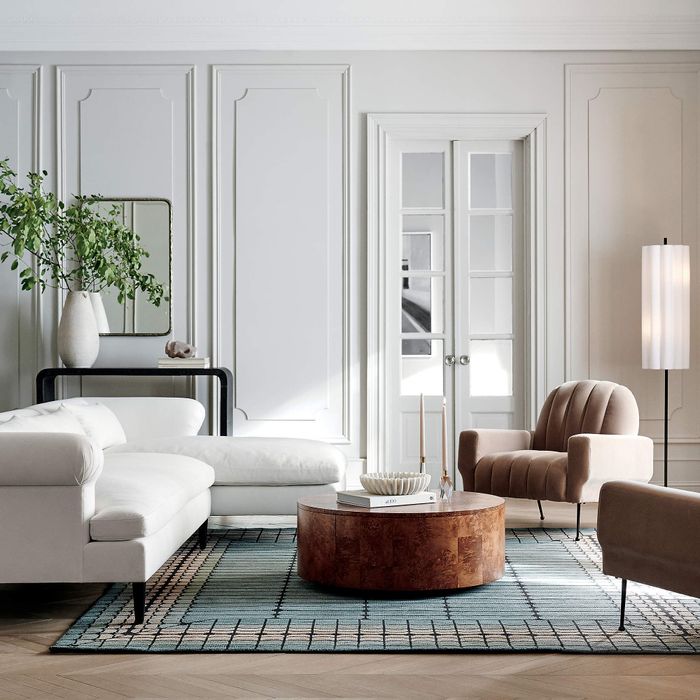 A lifestyle shot featuring a round coffee table with convenient storage space.