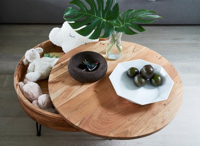The table with its top rotated to unveil the hidden storage compartment beneath.