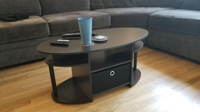 Reviewer photo of a black oval coffee table in a living room.