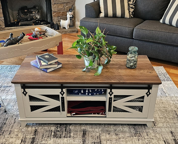 A reviewer photo showing the table in a sleek white finish.