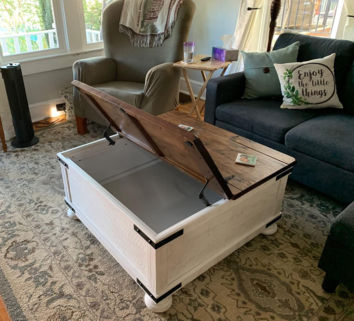 A photo of the farmhouse coffee table with the top lifted open.