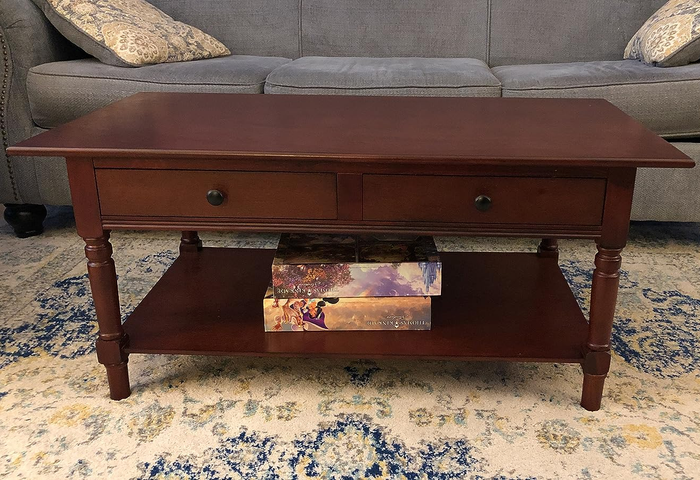 A photo from a reviewer showing the coffee table in a rich dark walnut finish.