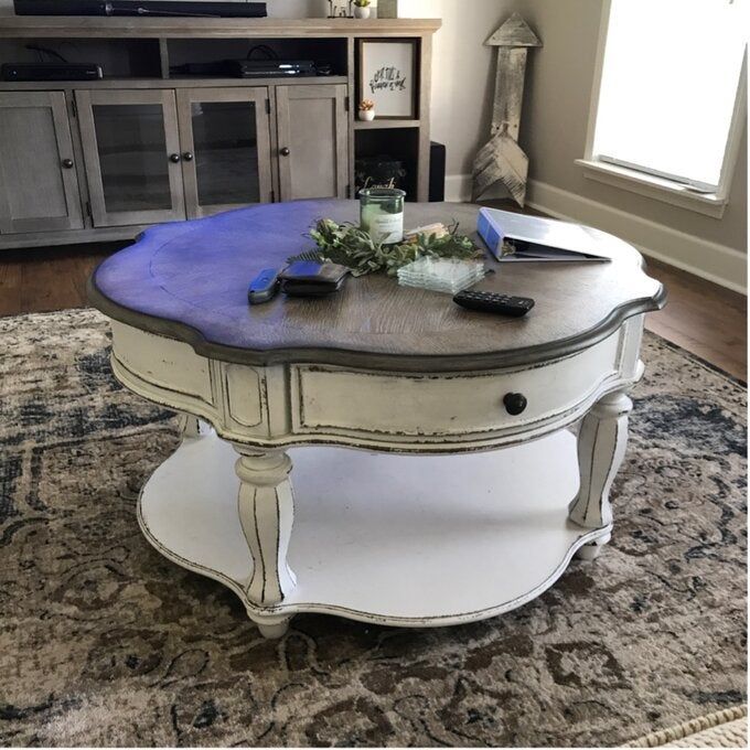 A reviewer photo of a round, vintage-style storage coffee table.