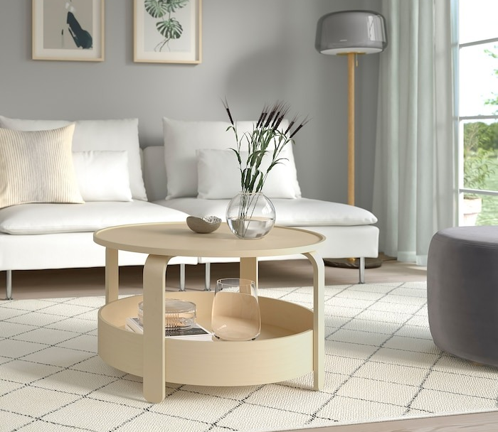 A round table featuring an open tray-style bottom.