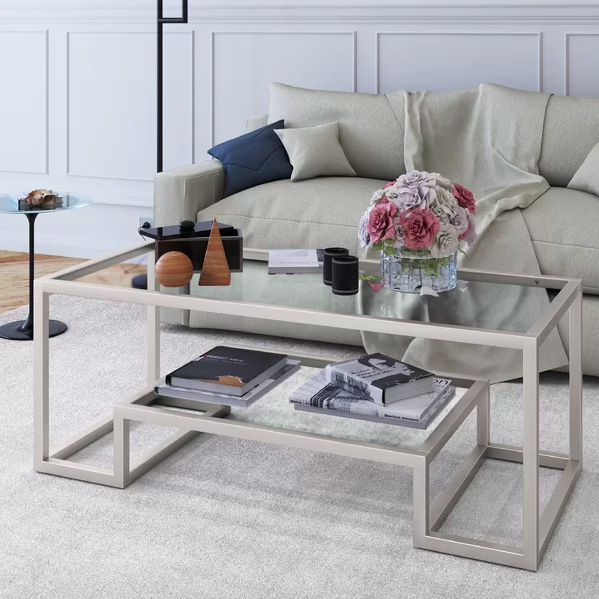 A gray sculptural coffee table featured in a living room setting.
