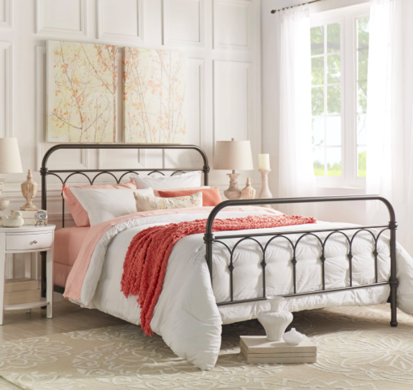 Metal bed frame with pink and red bedding
