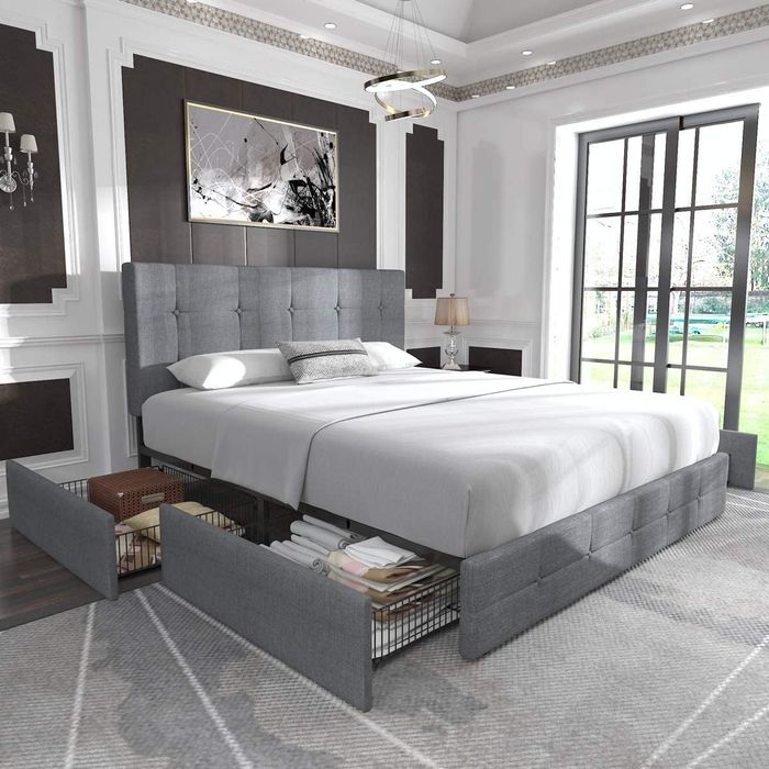 gray upholstered bed frame with drawers pulled out