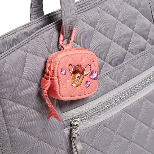 A quilted gray bag featuring a small pink pouch embroidered with a deer and flowers, attached to the strap