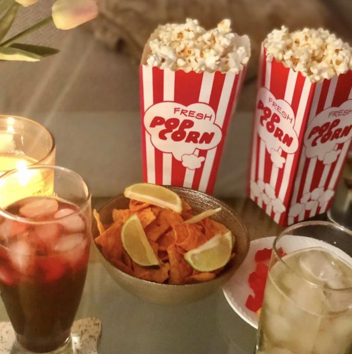 A reviewer using the vintage popcorn containers for movie night.