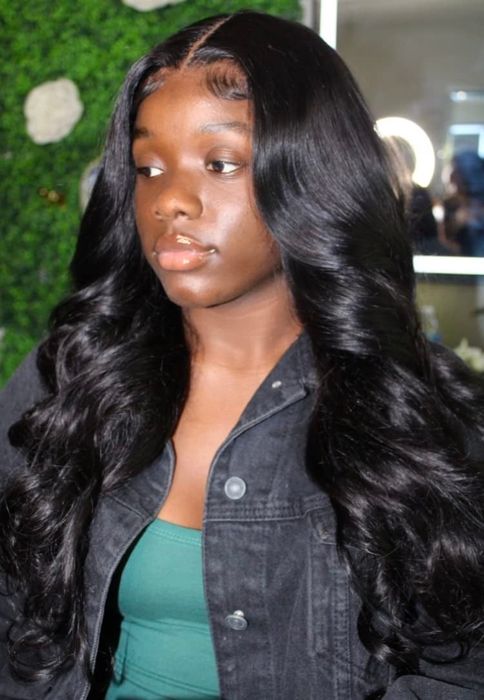 A reviewer showcasing a wig securely fixed with hair glue.