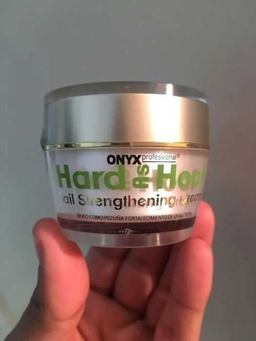 A reviewer holding the palm-sized jar.