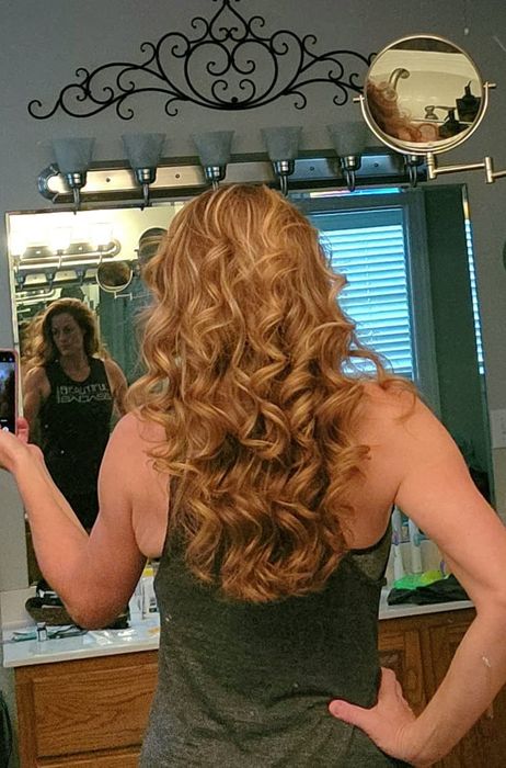 The reviewer’s hair after being styled with the curling iron.