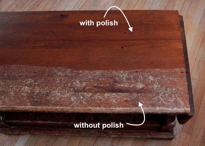 A reviewer’s photo showing a wood table that looks pristine on top with the label 'with polish' and scratched on the bottom labeled 'without polish'.