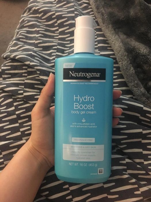 A reviewer holding the Neutrogena Hydro Boost bottle.