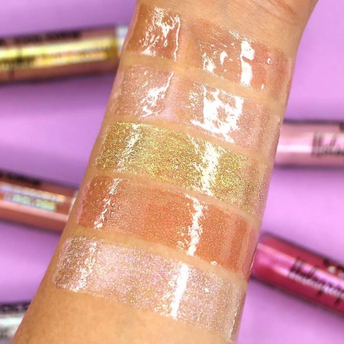 A photo showing a model's arm with five swatches of the high-shine gloss.