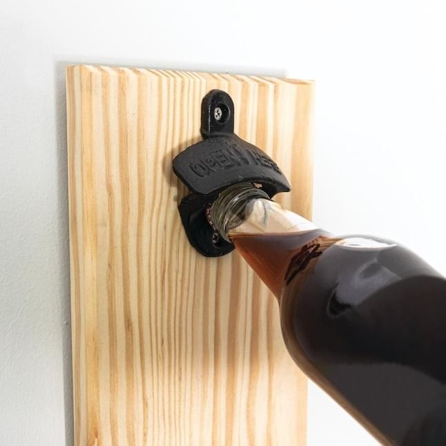 The bottle opener mounted on a wall, effortlessly opening a bottle with ease.