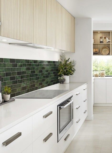 Green subway tiles used as a backsplash in a kitchen