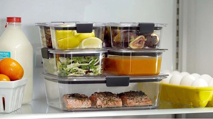 A neat stack of clear food storage containers arranged in a fridge.