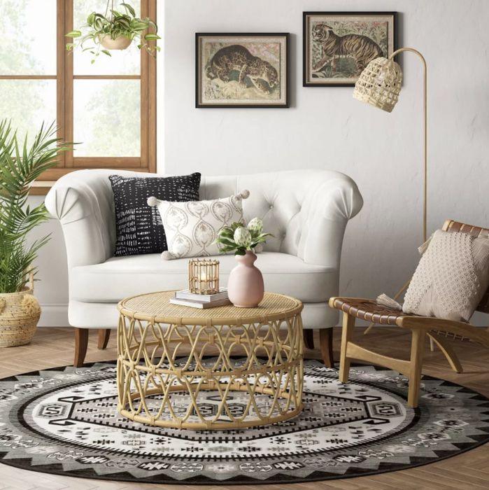 A patterned area rug placed beneath a boho-style coffee table for a cozy and stylish touch.