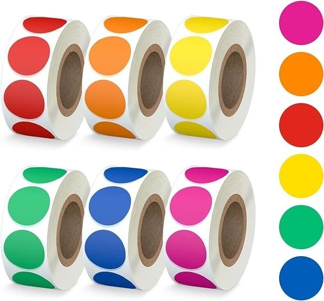 Rows of colorful circular label stickers, with matching color samples placed alongside them