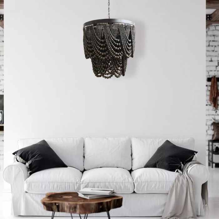 The chandelier hanging gracefully above a white couch.
