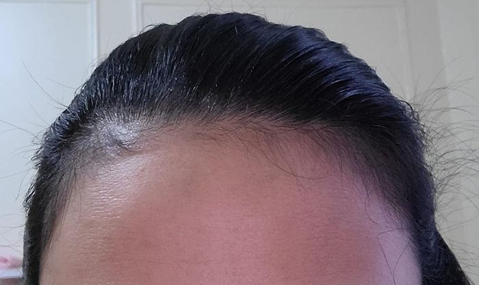 After using the finishing stick, the reviewer's hair appeared smooth and polished, with no flyaways or cowlicks in sight.