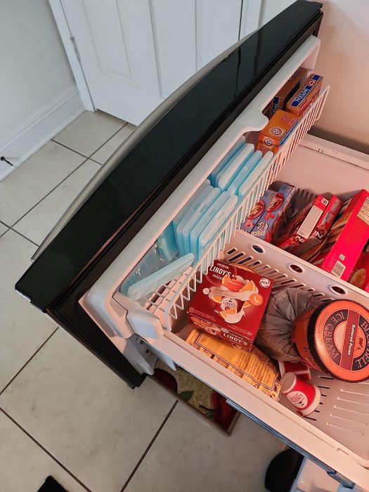 A freezer drawer packed neatly with slim ice packs, maximizing space while keeping items chilled