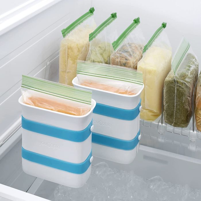 Freezer stocked with ziplock bags filled with frozen food, standing upright