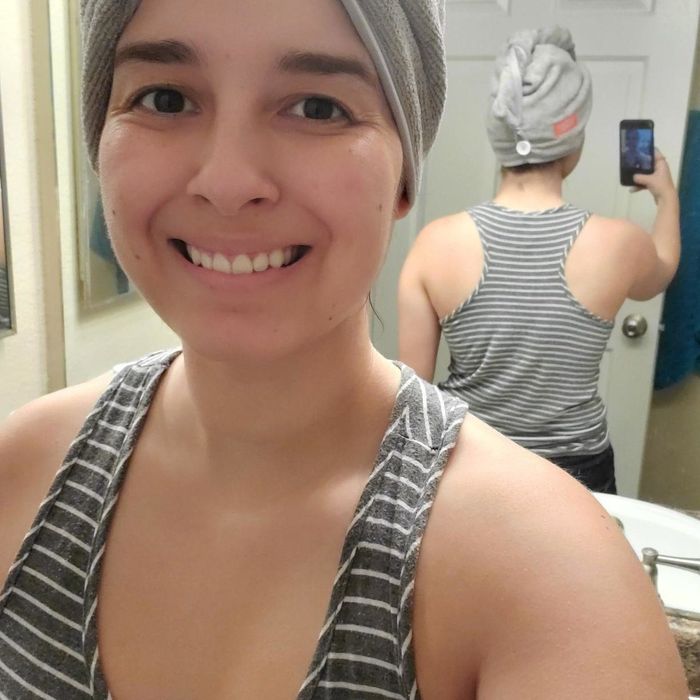 The reviewer is seen wearing the microfiber hair towel, showing how it fits perfectly for hassle-free drying.