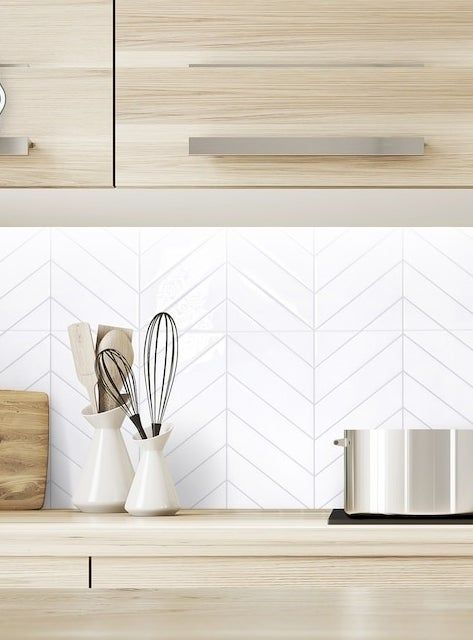 White chevron tiles as a backsplash in a kitchen