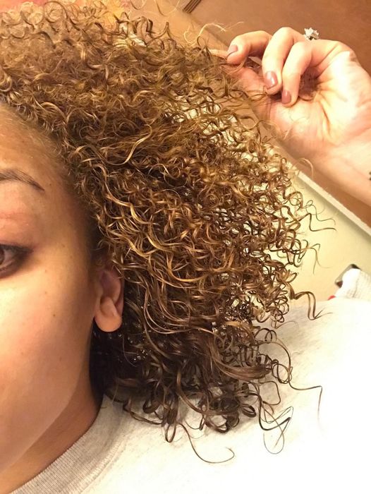 After using the OGX mist, the reviewer's hair is left looking smooth and effortlessly bouncy