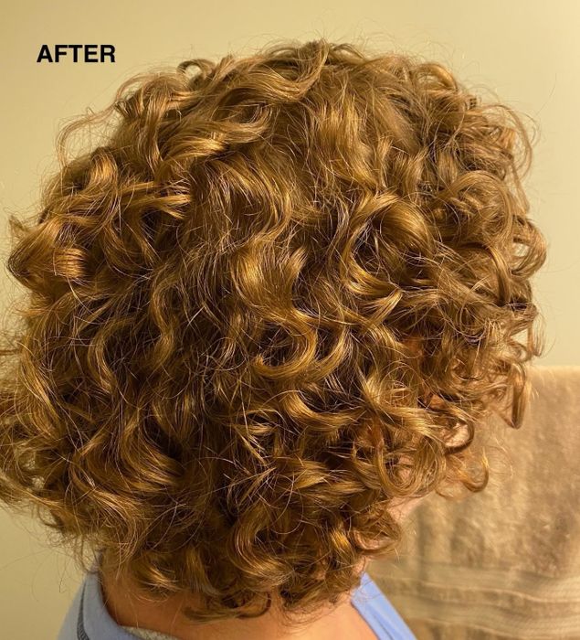 A photo of the reviewer’s hair after using the TGIN mousse, showing bouncy, defined curls that remain frizz-free.