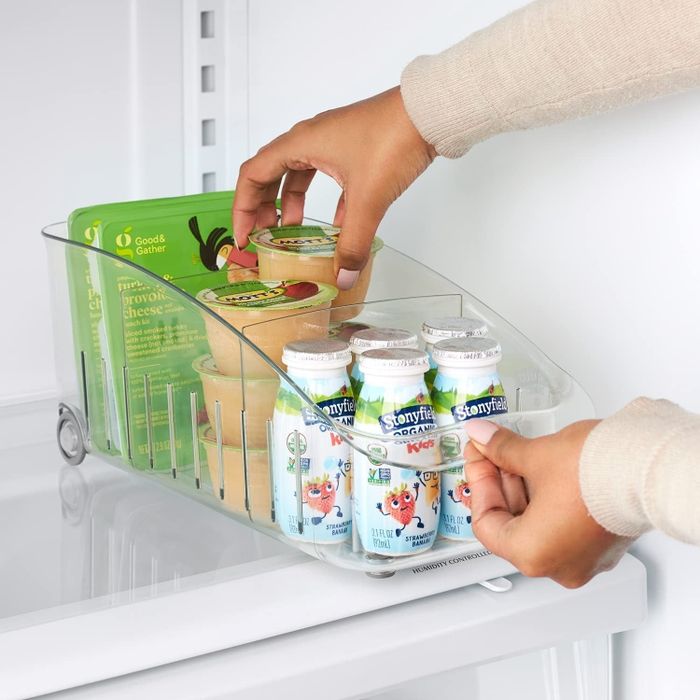 A person pulling a product from one of the bins