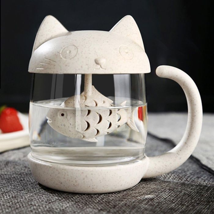 A white cat-shaped tea mug with a built-in fish-shaped infuser
