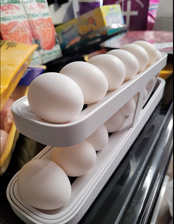 A two-tiered egg dispenser with twelve eggs, six placed on each level