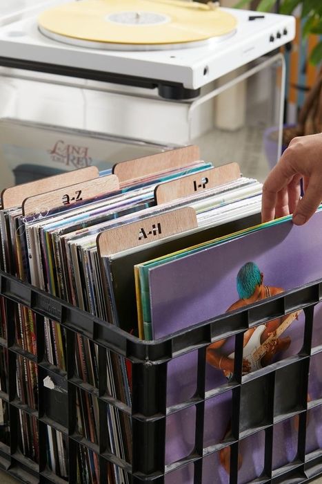 A crate filled with records, each neatly separated by the wooden dividers.