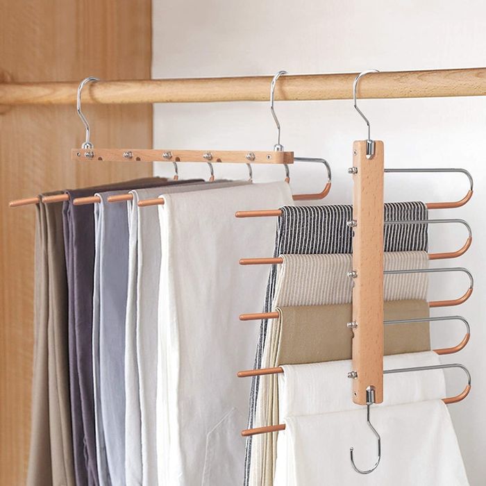 Five pairs of pants hanging on the versatile hanger, displayed in both hanging configurations.