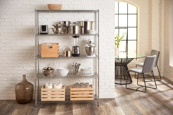 The metal shelf holding various kitchen equipment